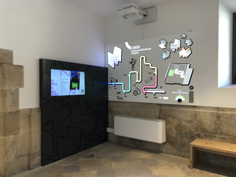 Interactive projected wall with capacitive touch interface showing timeline and floor plan navigation
